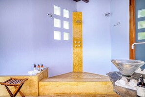 A bathroom with a bathtub, a shower, a vanity with a bowl sink, and a towel rack. - Villa Celeste Luxury Villa with Private Pool (Manuel Antonio)