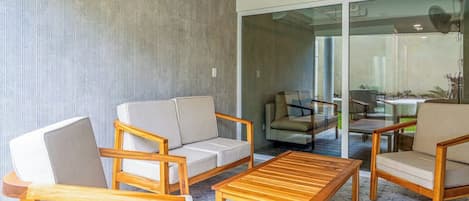 A modern living room with a sofa, armchairs, and a coffee table.