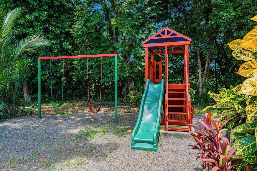 A playground with swings and a slide.