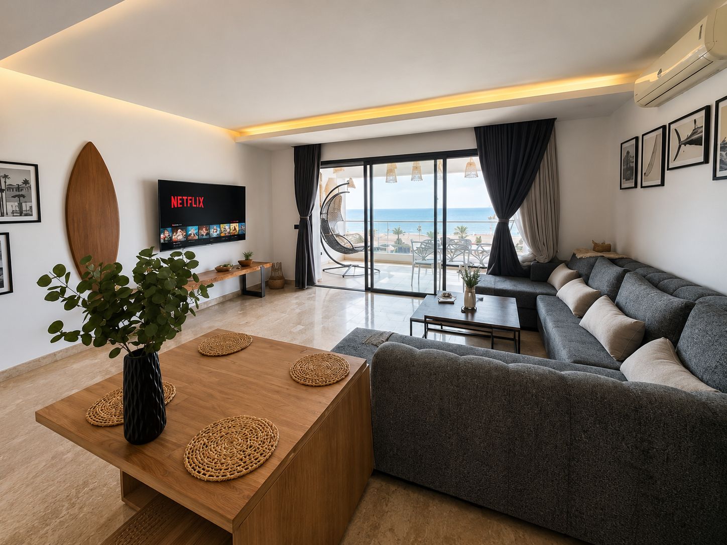 A modern living room with a grey sofa, a wooden coffee table, and a TV displaying Netflix.
