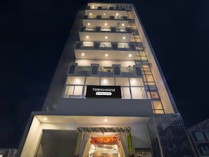 A multi-story building with a sign indicating 'TOWNHOUSE Company-Served.' - Deluxe Hotel Rk Heights And Banquets (Varanasi)