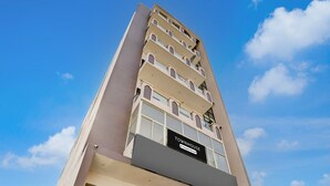 A multi-story building with a sign reading 'TOWNHOUSE.' - Deluxe Hotel Rk Heights And Banquets (Varanasi)