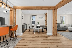 A modern interior with a dining area, kitchen, and living space. - Oswego River View Work Hub Near Phoenix (Phoenix)
