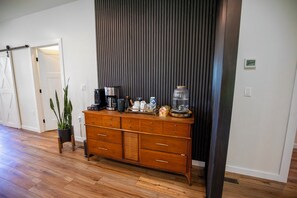 A room with a wooden dresser, a coffee maker, a kettle, a vase, and a plant. - Gameday Large Group Central 1 Mile From Stadium - Space for 16-19 (State College)