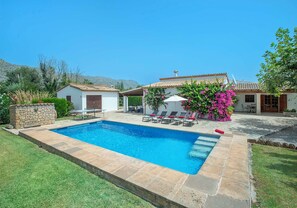 A swimming pool with a patio area, outdoor furniture, and a white building with a tiled roof. - Countryside Retreat in La Font, A/C, Private Pool, Large Garden - 15mins Walk to Old Town Pollenca! (Pollença)