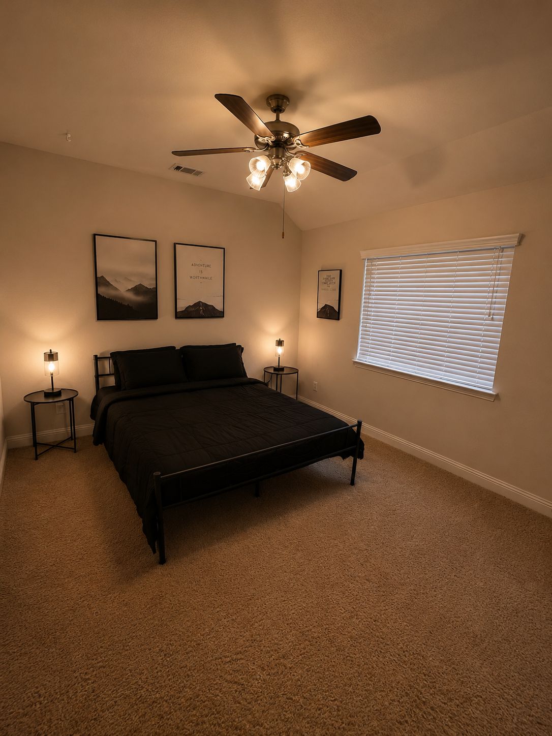 A bedroom with a bed, two bedside tables, a ceiling fan, and a window with blinds.