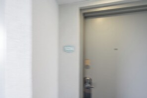 A closed door with a handle and a small, indistinct sign on the wall. - Amazing Ocean View Condo with Waterpark and Pool (Myrtle Beach)