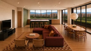 A modern living room with a large sofa, a dining table, and a TV. - Outsite Paris - Bastille - Work, Connect, Explore. (Paris)