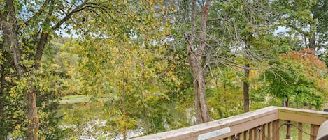 A wooden deck with a sign that reads 'EATS SLEEP FISH RECREATION.'