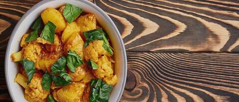 A bowl of food on a wooden surface.