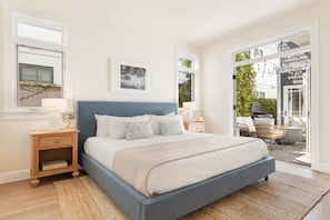 A bedroom with a large bed, bedside tables, a window, and a view of the outdoors. - Mins To Newport Beach, Pier, Water-Front Dining (Newport Beach)