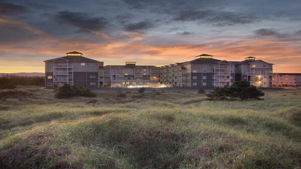 A multi-story hotel with a flat roof, balconies, and a central courtyard.
