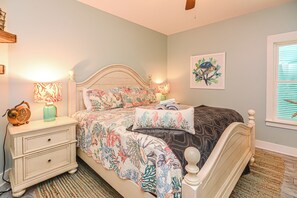 A bedroom with a bed, nightstands, a lamp, and a wall art piece. - 6007 Rookery 3 Just Breathe Sea Horse Cottage (Gulf Shores)