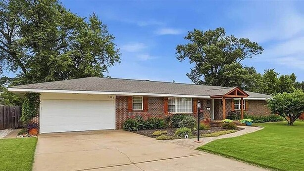 A single-story house with a garage, a front lawn, and a mailbox. - Poolside Pokes...Walk to OSU!!! (Stillwater)
