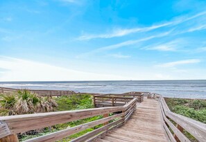 A wooden boardwalk leading to a beach with ocean views. - Luxe 4BR: Boardwalk + 3rd Floor Deck (Port Aransas)