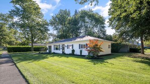 A single-story house with a well-maintained lawn and a driveway leading to the front door. - Gather at 104 - Walk to Downtown Perrysburg (Perrysburg)