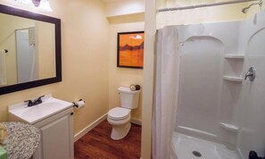 A bathroom with a toilet, sink, and shower. - Forest Den at Buckhorn Cove near Mendocino - cozy gas fireplace & sleeps 4 (Mendocino County)