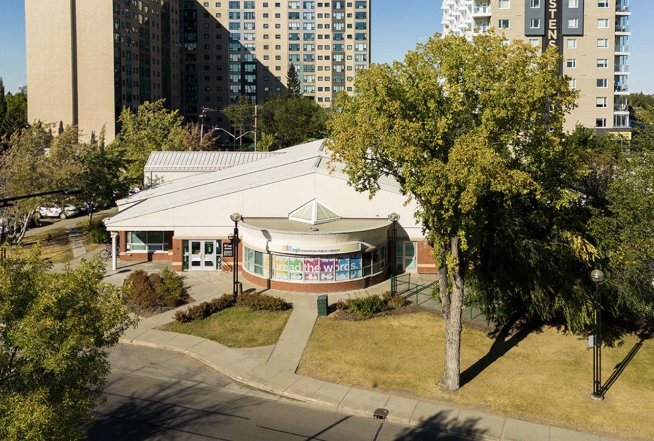 A public library with a curved roof and a sign that reads 'bread the words.'