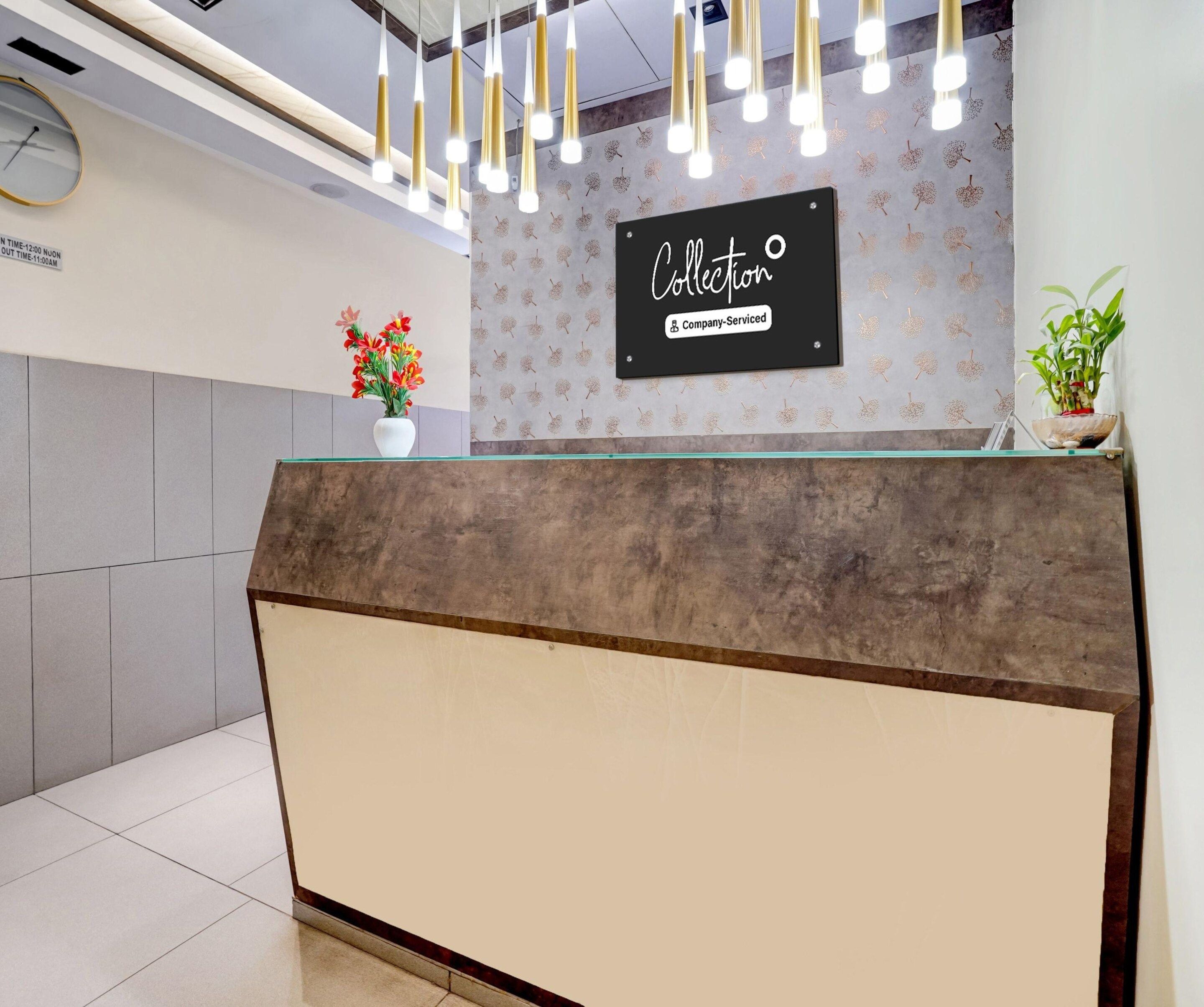 A reception desk with a sign that reads 'Collection & Company-Serviced'.
