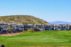 A modern resort with multiple buildings, a well-maintained golf course, and a hilly backdrop. - Luxury Golf Course-View - Heated Pool & Hot Tub (Hurricane)