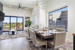 Un comedor moderno con una mesa grande, asientos cómodos y vistas al exterior.