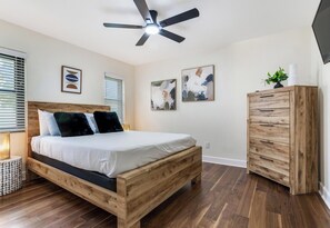 A bedroom with a wooden bed, a ceiling fan, and a wooden wardrobe. - Private Pool Retreat, Spacious 3BR + Large Yard (Brandon)