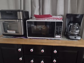 A kitchenette with a microwave, toaster, and coffee maker on a wooden countertop. - Private apartment in downtown Tallahassee. Private entrance. Access to backyard. (Tallahassee)