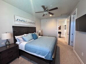 A bedroom with a bed, nightstands, a ceiling fan, and artwork on the walls. - Peaceful Poolside Perfection!  4 bedroom 3-with King Beds & ensuites, 4-1/2 bath (Washington)
