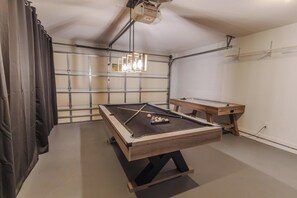 A pool table with balls, a cue stick, and a pool table cloth. - Peaceful 3BR 2BTH Villa | Private Pool | Game Room | Champions Gate Area (Davenport)