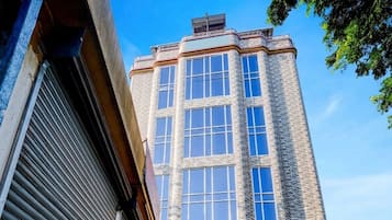 A corner building with a brick facade and multiple windows.