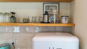 A kitchen with a coffee maker, a toaster, and a white appliance on the counter.