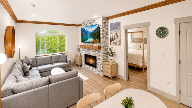 A living room with a fireplace, a sofa, a dining table, and a view of a bedroom. - 2070/72 | 2BR Modern Villa | Full Kitchen | Pool (Midway)
