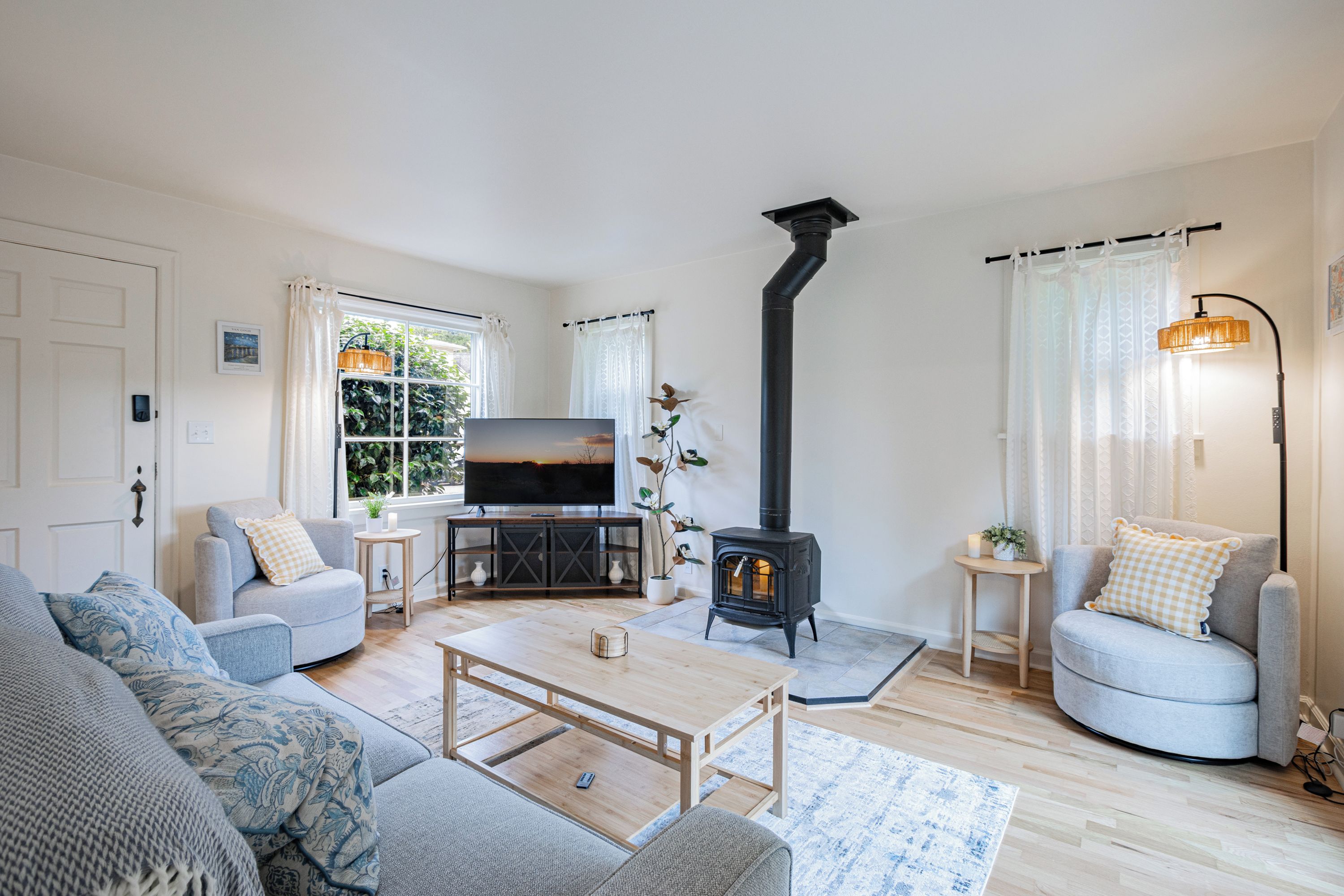 A cozy living room with a fireplace, a television, and comfortable seating.