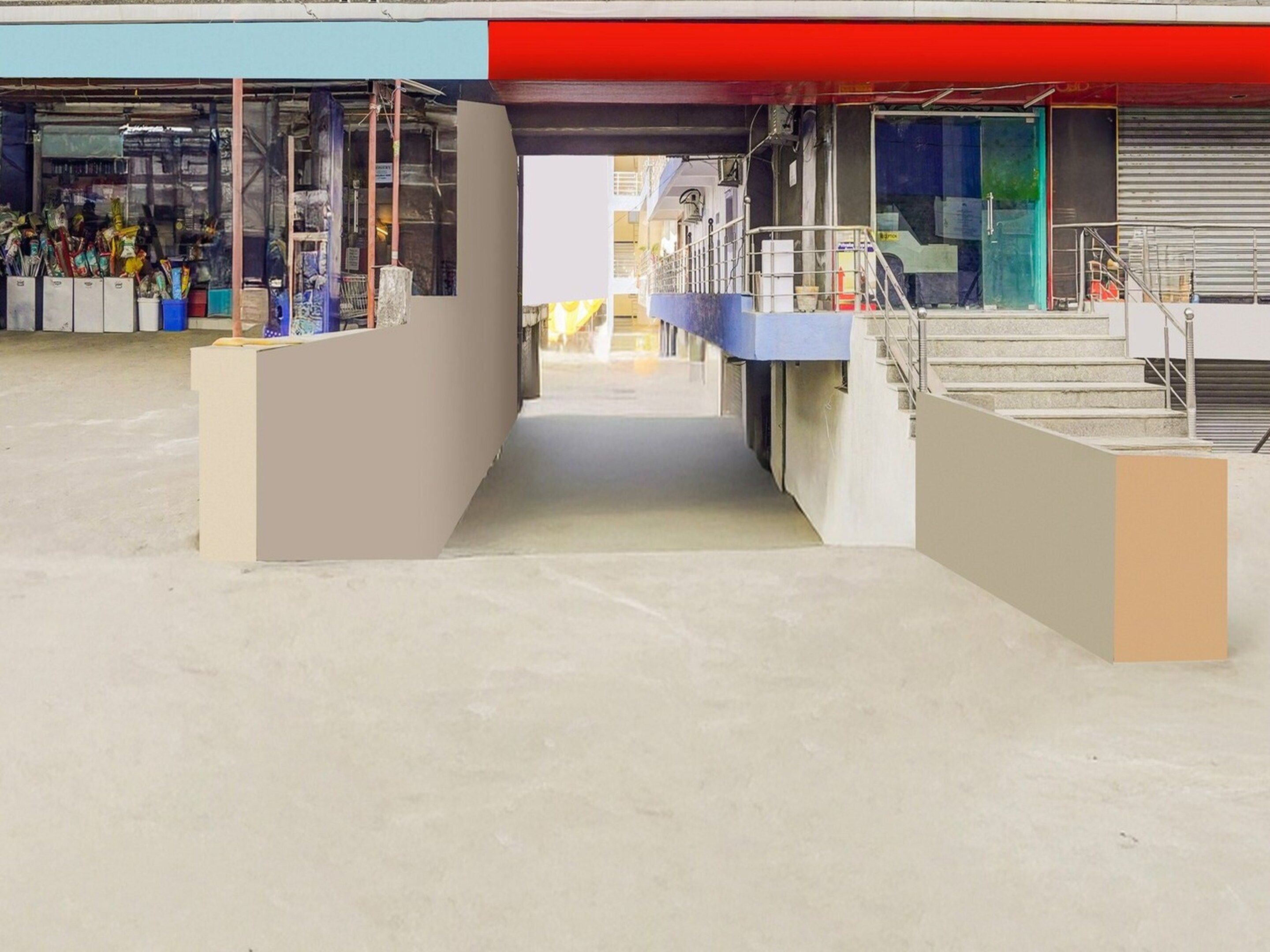 A commercial space with a central walkway, storefronts on either side, and a staircase leading to an upper level.