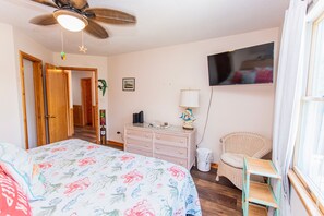 A bedroom with a bed, dresser, chair, ceiling fan, and a television on the wall. - Oceanside, Priv Pool, Hot Tub, comm amenities - VOH1277, Beach Mode (Corolla)
