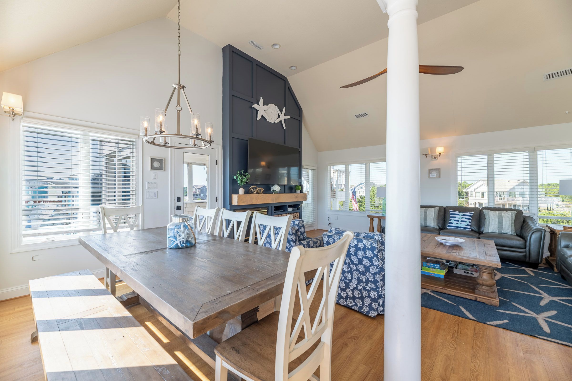 A spacious living area with a dining table, seating, and a fireplace.