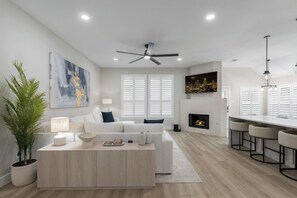 A modern living room with a sofa, coffee table, and a fireplace. - Luxury 5BR Resort with Hot Tub 12 miles from ATT Stadium Sleeps 10 (Mansfield)