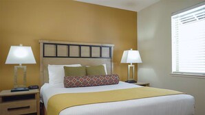 A hotel room with a bed, two bedside tables, lamps, and a window with blinds. - 2-Bedroom South Tahoe Resort Next to Beach & Zephyr Cove - AC & fitness room (Zephyr Cove)