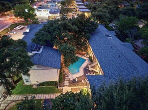 A residential property with a swimming pool, a covered patio, and a driveway. - Gated Austin 2BR Condo+ Pool - Near South Congress (Austin)
