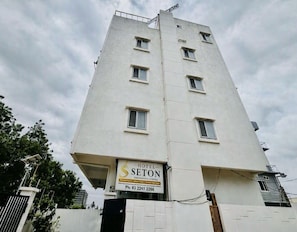 A multi-story hotel building with a sign for 'HOTEL SETON' and a contact number. - Classic MJR Square Mall (Hyderabad)