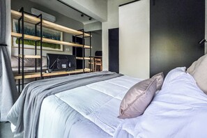 A modern bedroom with a bed, a desk, and a shelving unit. - MOT Rentals + River Plate 2 Lux Lofts A - 100m to Stadium (Buenos Aires)