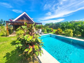 A swimming pool with a house in the background. - Beautiful 3-bedroomChalet, perfer or families and privacy, 5min in car from twon (San Carlos)