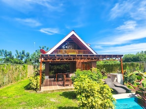 A two-story house with a balcony, a patio with furniture, and a swimming pool. - Beautiful 3-bedroomChalet, perfer or families and privacy, 5min in car from twon (San Carlos)