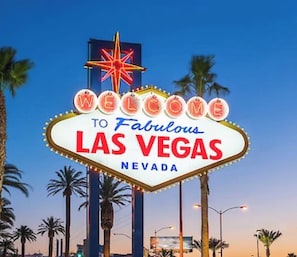 A neon sign with 'WELCOME TO Fabulous LAS VEGAS NEVADA' text. - Experience Vegas in Comfort • 1BR Suite • No Resort Fees! (Las Vegas)
