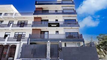 A multi-story building with a sign indicating 'TOWNHOUSE Company Serviced.'