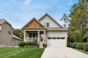 A two-story house with a front porch, a garage, and a well-maintained lawn. - Mountain Gem - Minutes to Downtown WJ - Shops - Hiking (West Jefferson)