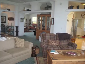 A spacious living room with a sofa, armchair, and coffee table. - 14 Oaks Ranch in Sierra Foothills; perfect for family getaways (Oroville)