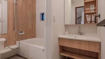 A bathroom with a shower, a bathtub, a sink, and a mirror.