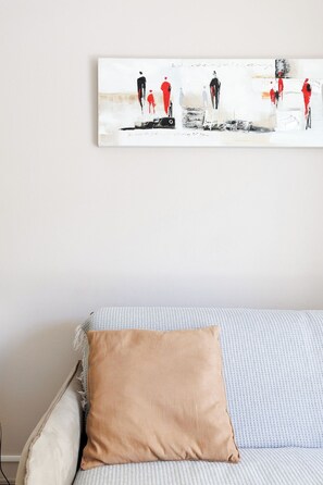 A room with a bed, a pillow, and a wall-mounted abstract painting. - Upstays Cosy Calm 1 Bedroom with terrace and AC (Cannes)