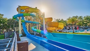 A water park with multiple water slides and a pool area. - Waterfront RV Oasis: Dock & Pavilion | Lot 561 (River Ranch)